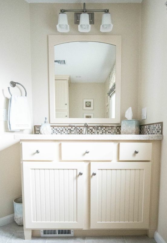Design ideas for a small beach style 3/4 bathroom in Providence with shaker cabinets, white cabinets, brown tile, white tile, glass tile, beige walls, an undermount sink and marble benchtops.