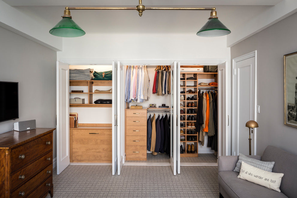 Design ideas for a transitional men's dressing room in New York with flat-panel cabinets, medium wood cabinets, carpet and grey floor.