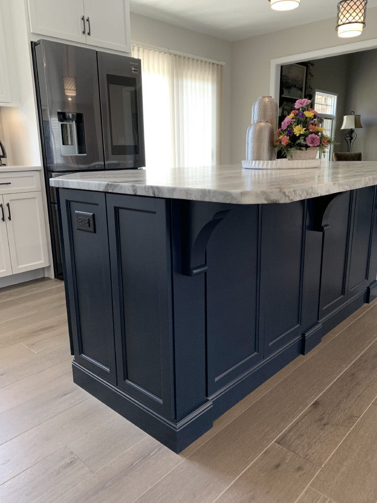Inspiration for a large transitional l-shaped eat-in kitchen in Other with an undermount sink, recessed-panel cabinets, white cabinets, quartz benchtops, grey splashback, ceramic splashback, stainless steel appliances, vinyl floors, with island, grey floor and white benchtop.