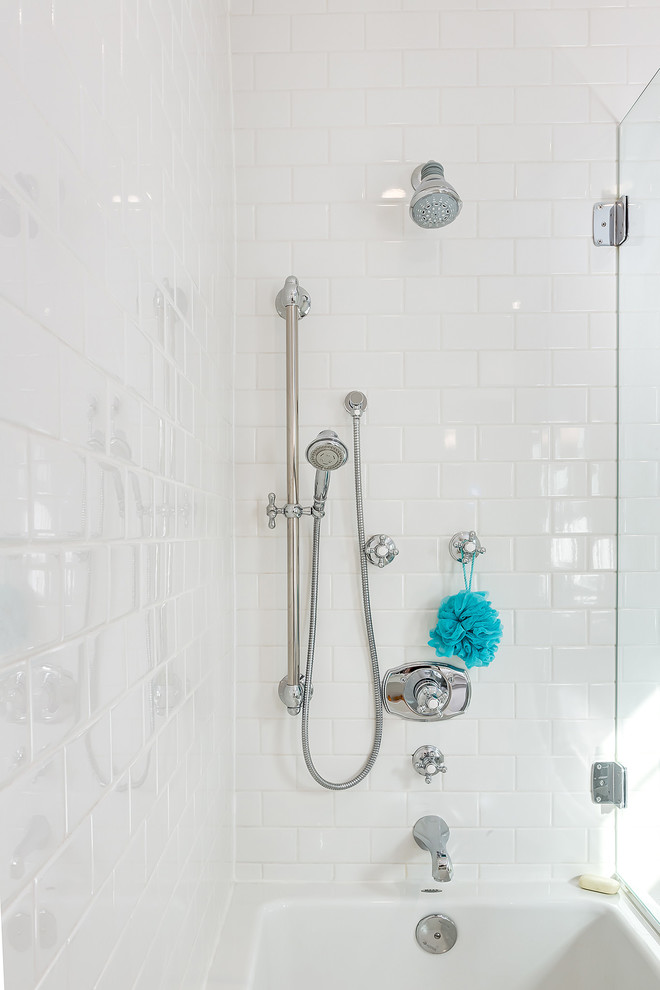 Mid-sized traditional master bathroom in Calgary with a shower/bathtub combo, white tile and ceramic tile.