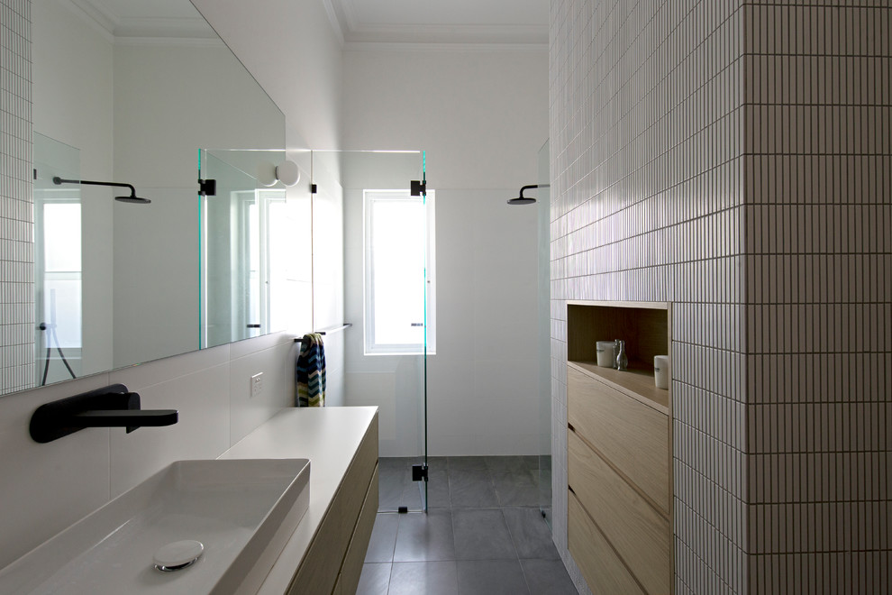 This is an example of a contemporary 3/4 bathroom in Perth with light wood cabinets, a curbless shower, white tile, mosaic tile, white walls, slate floors, a vessel sink, grey floor, a hinged shower door, white benchtops and flat-panel cabinets.