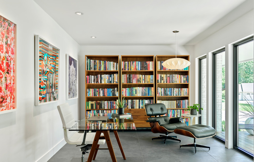 Mittelgroßes Modernes Lesezimmer mit weißer Wandfarbe, Porzellan-Bodenfliesen, freistehendem Schreibtisch und grauem Boden in Kansas City