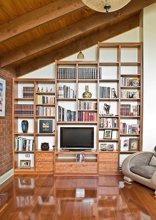 Large contemporary open concept living room in Melbourne with a freestanding tv, white walls, medium hardwood floors and no fireplace.