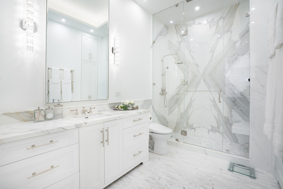 Inspiration for a transitional master bathroom in New York with recessed-panel cabinets, white cabinets, an alcove shower, an undermount sink, marble benchtops, grey floor, a hinged shower door, a single vanity and a built-in vanity.