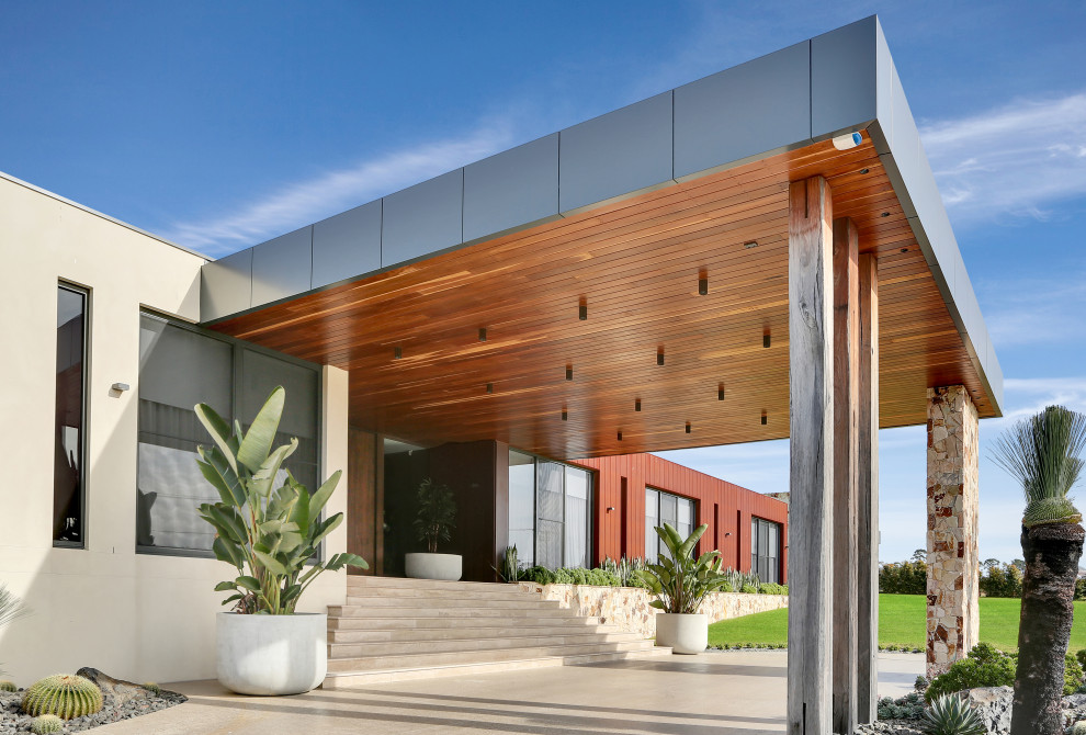 Geräumiges Modernes Einfamilienhaus mit Glasfassade, beiger Fassadenfarbe, Flachdach, Blechdach und grauem Dach in Sydney