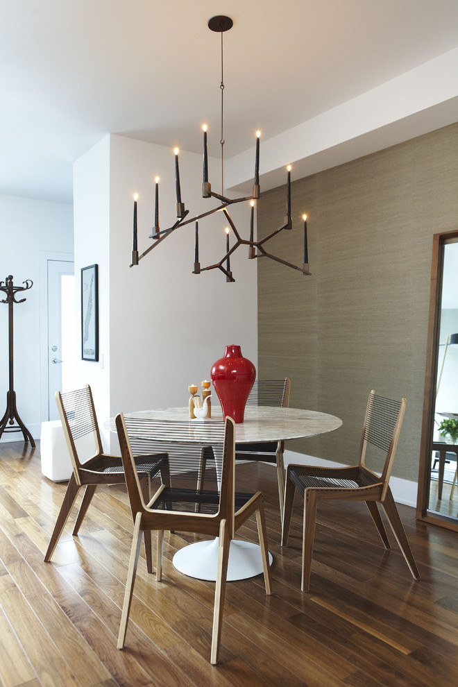 Photo of a small contemporary open plan dining in Toronto with medium hardwood floors, brown walls, no fireplace and brown floor.