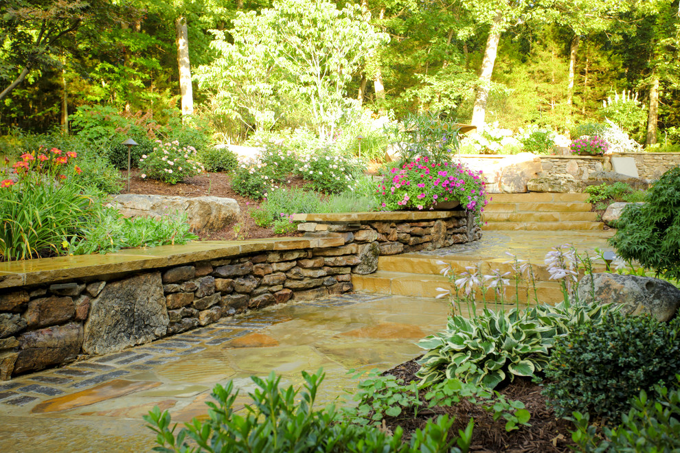 Scandinavian backyard shaded garden in St Louis with natural stone pavers for summer.