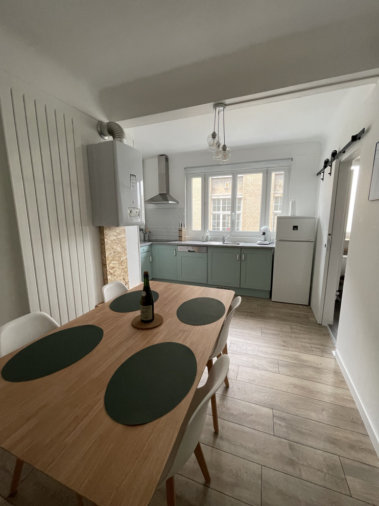 Inspiration for a medium sized scandi open plan dining room in Le Havre with white walls, light hardwood flooring, beige floors and a drop ceiling.