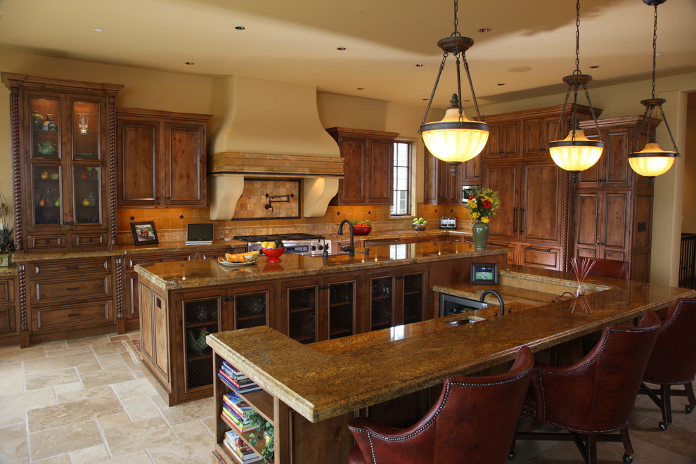 This is an example of a large traditional l-shaped open plan kitchen in Seattle with granite benchtops, panelled appliances, an undermount sink, recessed-panel cabinets, yellow splashback, ceramic splashback, medium wood cabinets, multiple islands and porcelain floors.