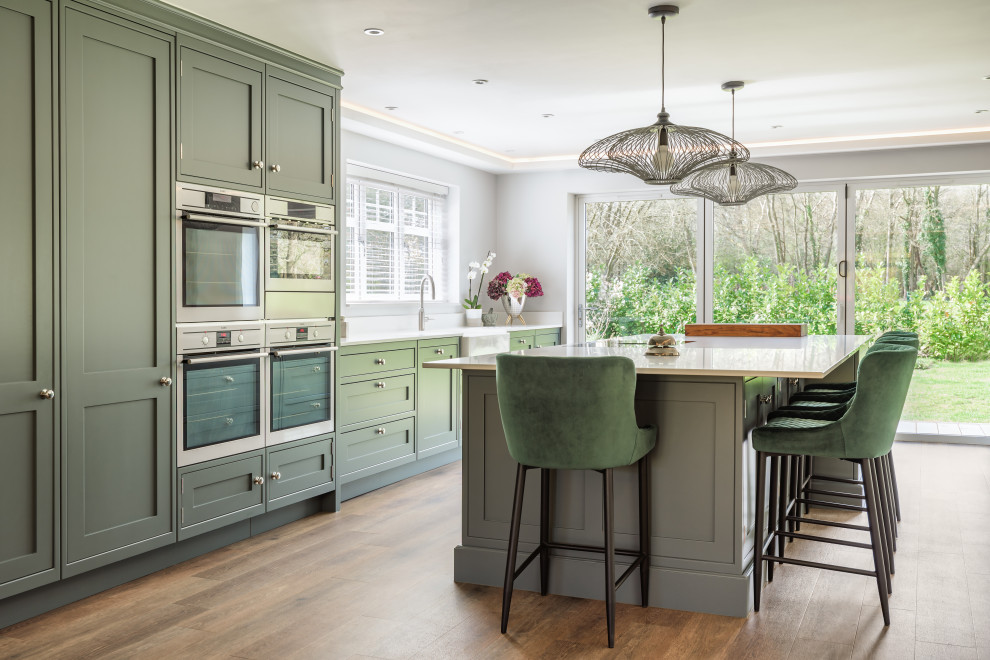 Example of a large transitional single-wall open concept kitchen design in Sussex with an island