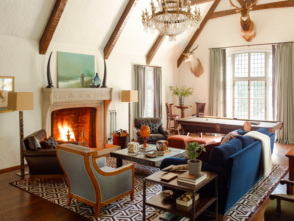 Inspiration for a large transitional family room in New York with white walls, medium hardwood floors and a standard fireplace.