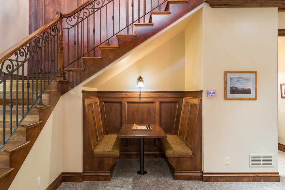 Photo of a large country wood l-shaped staircase in Denver with wood risers and metal railing.