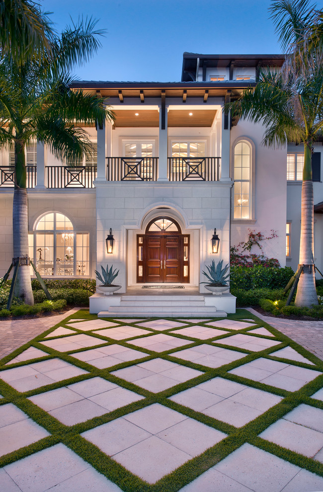 Huge tropical beige two-story mixed siding exterior home idea in Miami