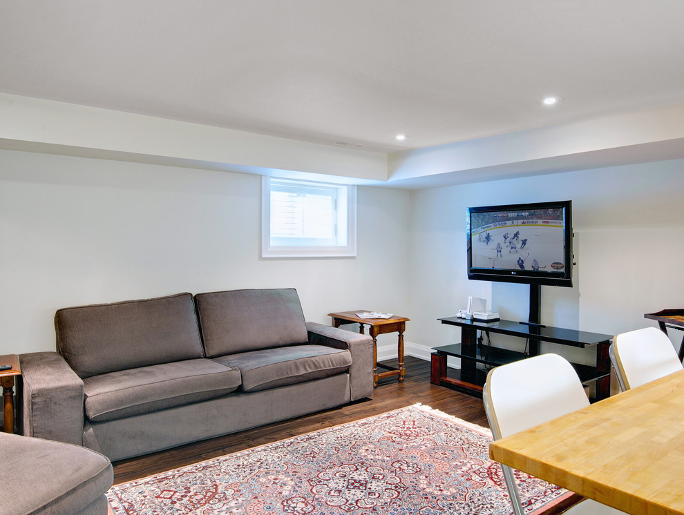 Mid-sized arts and crafts look-out basement in Toronto with grey walls and dark hardwood floors.