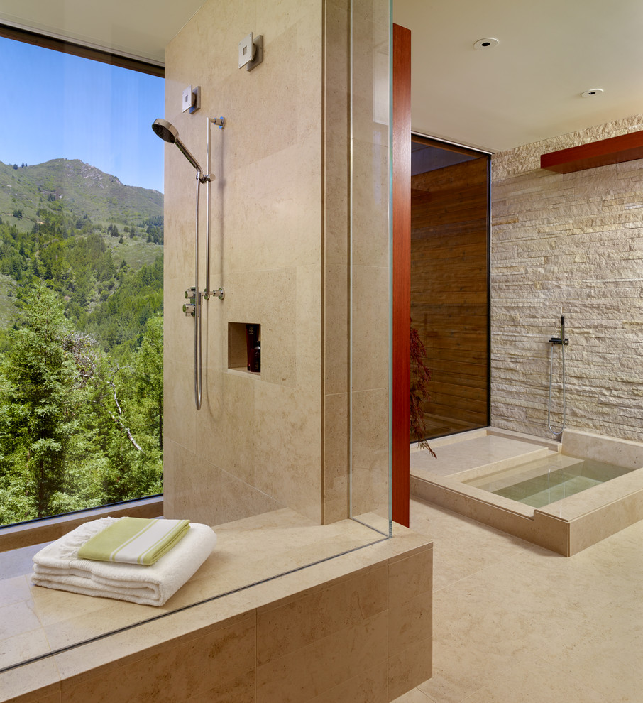 This is an example of a large contemporary master bathroom in San Francisco with a japanese tub, beige tile, an undermount sink, flat-panel cabinets, medium wood cabinets, an open shower, a one-piece toilet, beige walls, limestone floors, an open shower, beige floor and limestone.