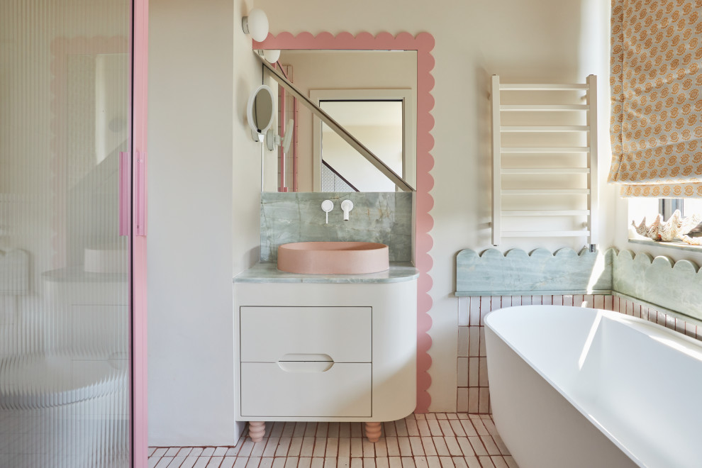 Inspiration for an eclectic ensuite bathroom in London with flat-panel cabinets, white cabinets, a freestanding bath, an alcove shower, white walls, a vessel sink, marble worktops, multi-coloured floors, a hinged door, multi-coloured worktops, a single sink and a built in vanity unit.