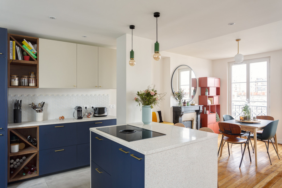 Photo of a mid-sized contemporary u-shaped open plan kitchen in Paris with an undermount sink, beaded inset cabinets, blue cabinets, terrazzo benchtops, white splashback, ceramic splashback, panelled appliances, ceramic floors, a peninsula, grey floor and white benchtop.