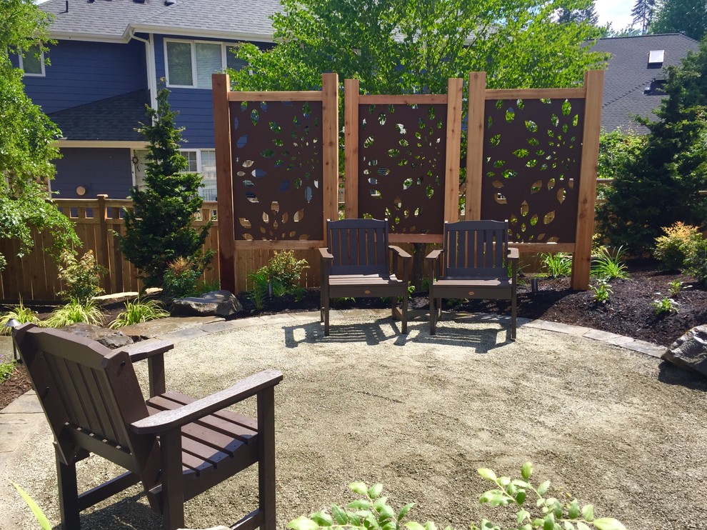 Photo of a mid-sized rustic backyard gravel landscaping in Seattle.