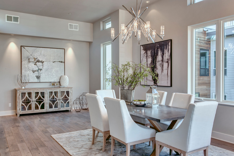 Inspiration for a transitional dining room in Seattle with grey walls and light hardwood floors.