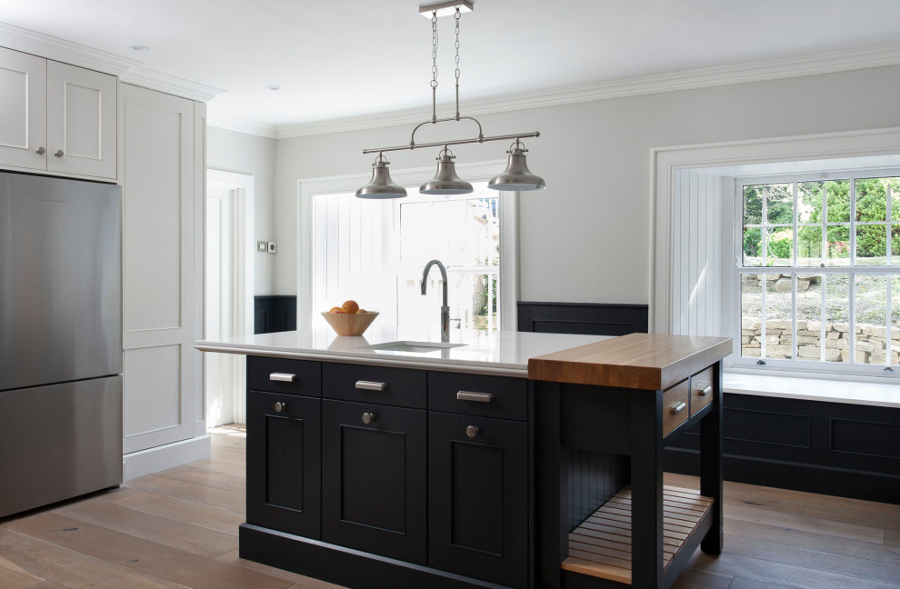 This is an example of a large traditional u-shaped kitchen in Other with shaker cabinets and black cabinets.