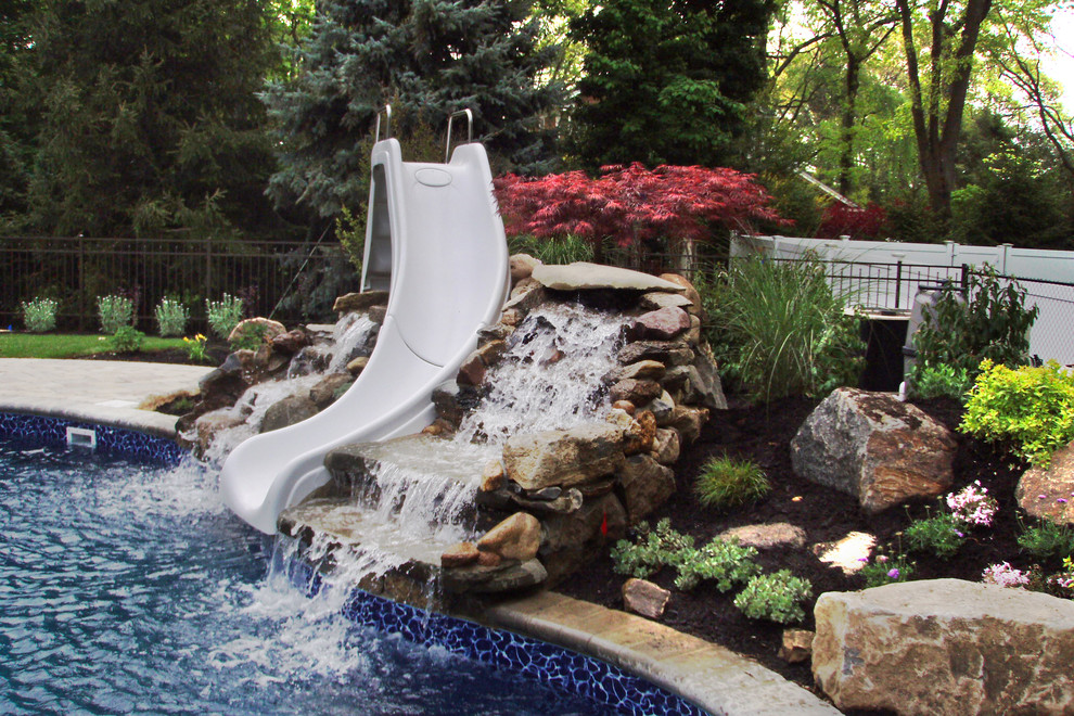 Inspiration for a contemporary backyard custom-shaped pool in New York with concrete pavers.