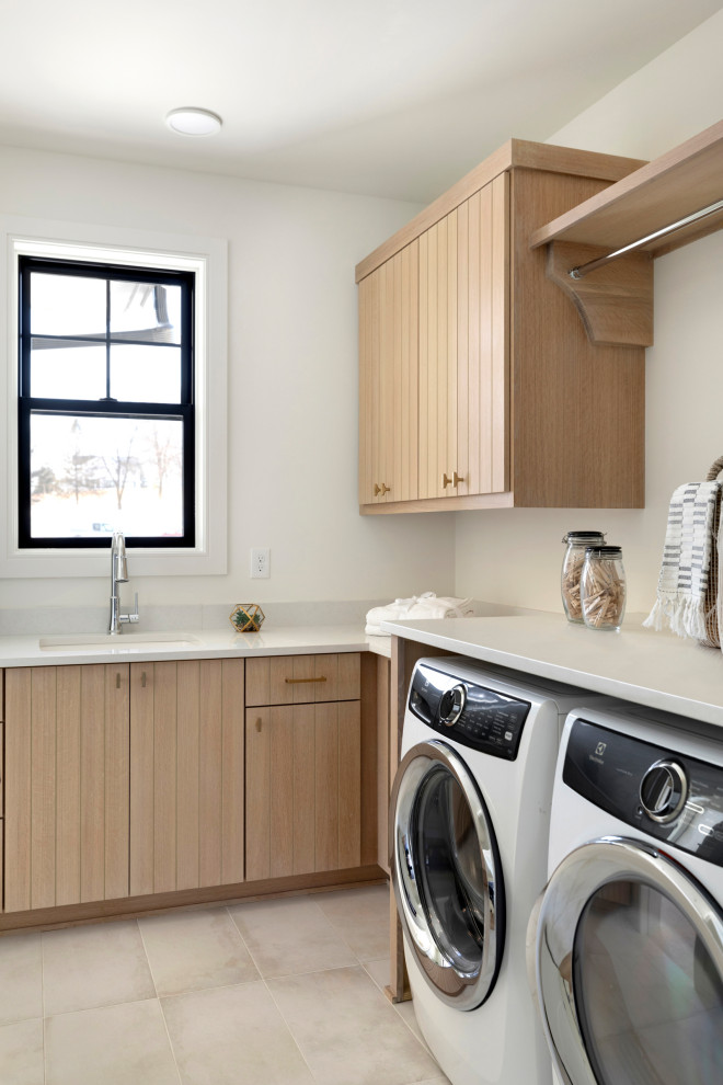 Photo of a scandinavian laundry room in Minneapolis with light wood cabinets.