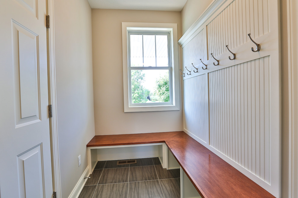 Photo of a mid-sized modern mudroom in Minneapolis with grey walls and ceramic floors.
