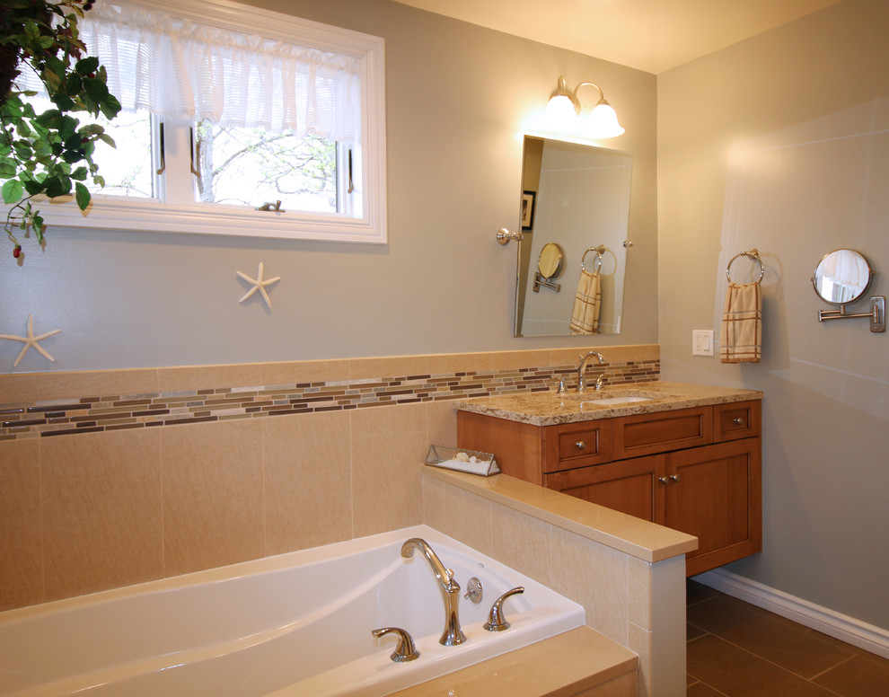 Mid-sized transitional master brown tile and porcelain tile porcelain tile drop-in bathtub photo in Detroit with flat-panel cabinets, light wood cabinets, a one-piece toilet, green walls, an undermount sink and quartz countertops