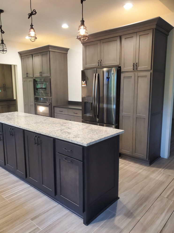 Kitchen - mid-sized transitional porcelain tile and gray floor kitchen idea with shaker cabinets, gray cabinets, quartz countertops, stainless steel appliances, an island and white countertops