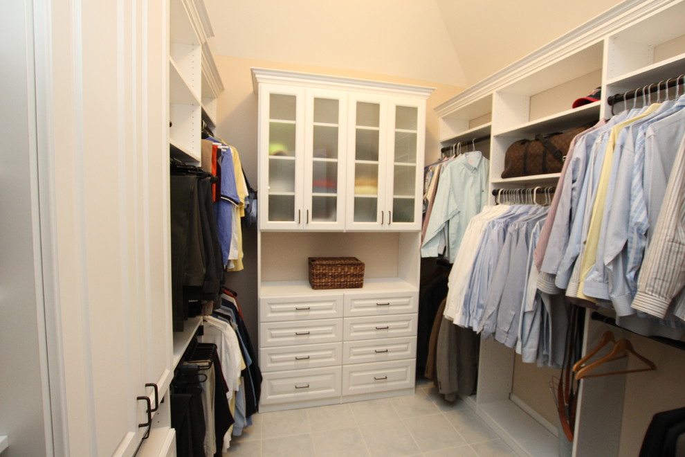 Photo of a mid-sized men's walk-in wardrobe in Philadelphia with raised-panel cabinets, white cabinets and terra-cotta floors.