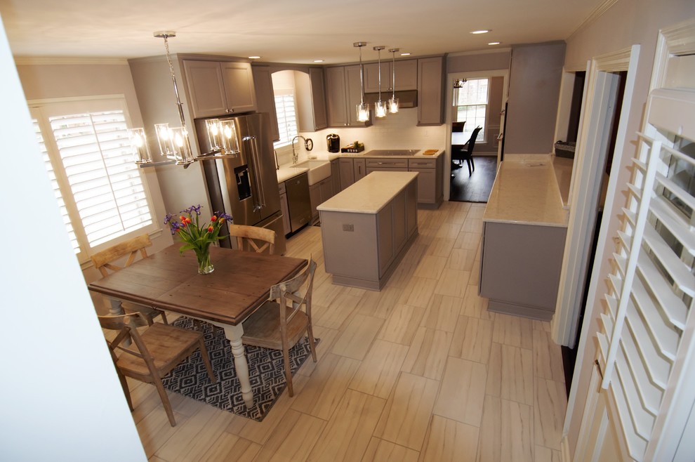 Inspiration for a large transitional u-shaped porcelain tile and beige floor eat-in kitchen remodel with a farmhouse sink, recessed-panel cabinets, gray cabinets, granite countertops, white backsplash, subway tile backsplash, stainless steel appliances, an island and beige countertops