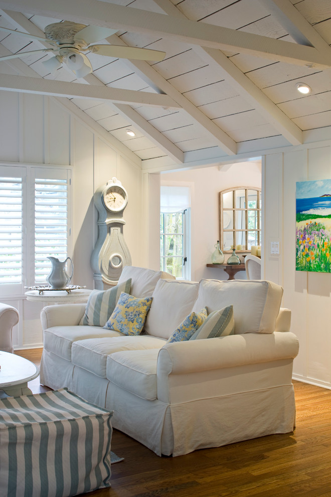 Inspiration for a mid-sized transitional formal and open concept medium tone wood floor living room remodel in Other with white walls, a standard fireplace, a stone fireplace and a wall-mounted tv