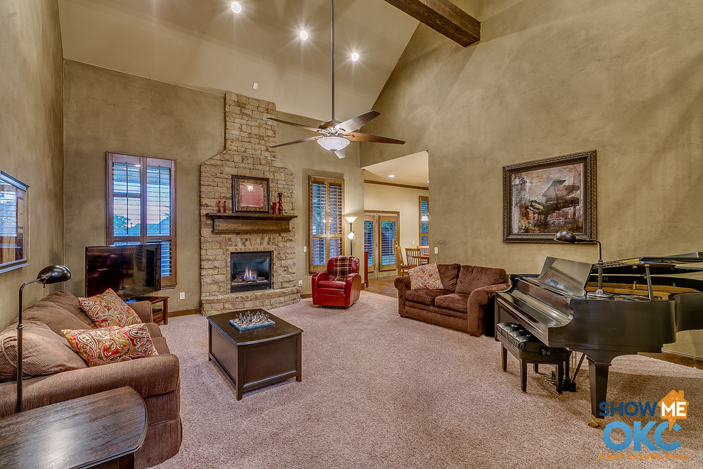 Large traditional open concept living room in Oklahoma City with a standard fireplace, a stone fireplace surround and a freestanding tv.