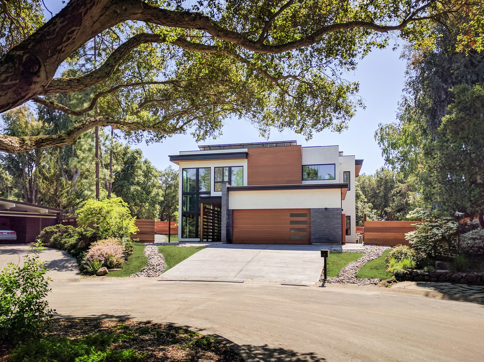 Inspiration for a large modern white two-story mixed siding flat roof remodel in San Francisco