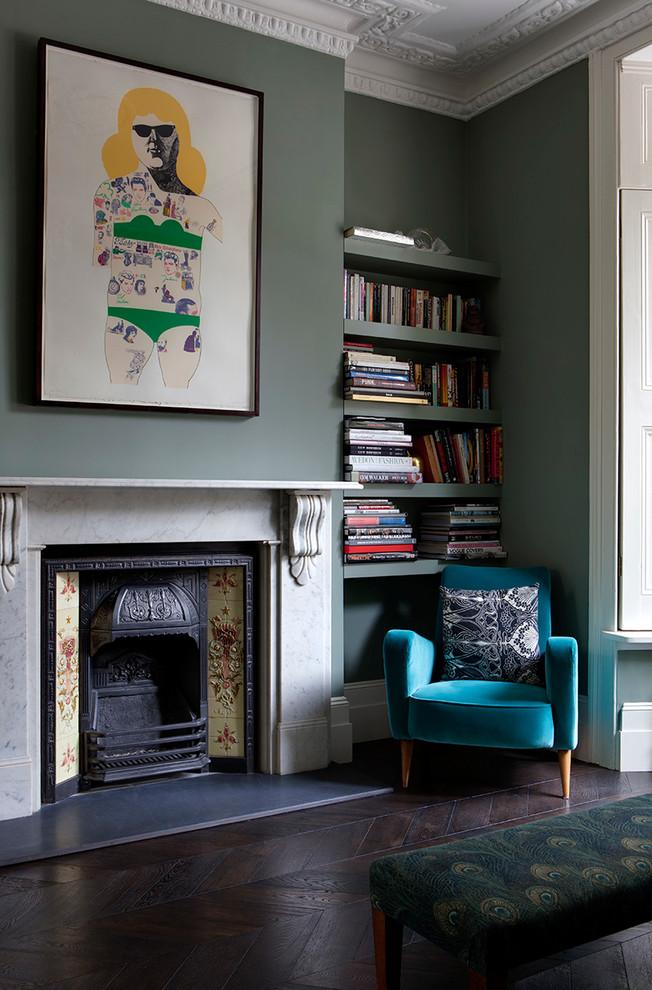 Design ideas for a traditional living room in London with green walls, dark hardwood floors and no tv.