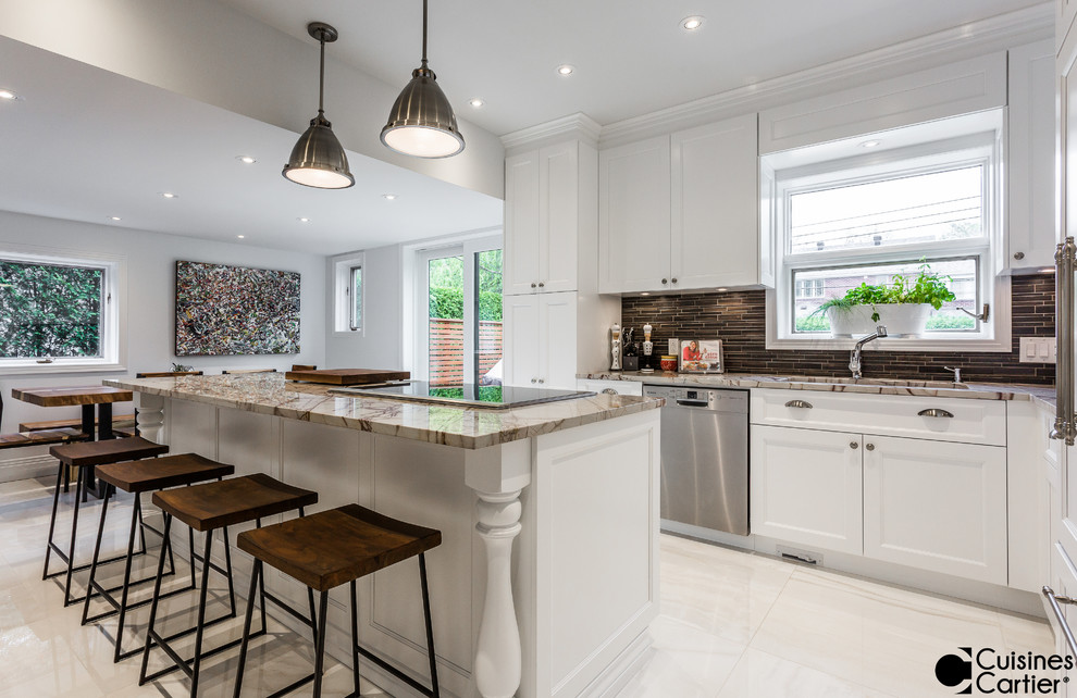 Photo of a large transitional l-shaped eat-in kitchen in Montreal with an undermount sink, shaker cabinets, white cabinets, granite benchtops, brown splashback, porcelain splashback, panelled appliances, ceramic floors and with island.