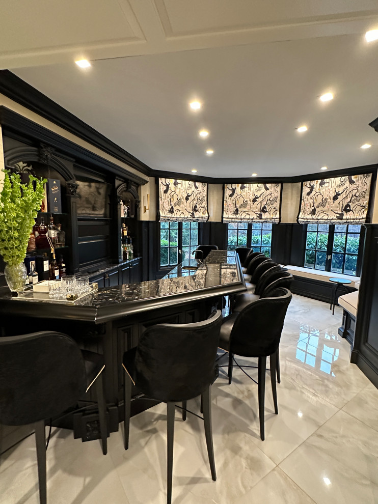 Design ideas for a medium sized traditional galley breakfast bar in New York with black cabinets, granite worktops, marble flooring, beige floors and black worktops.