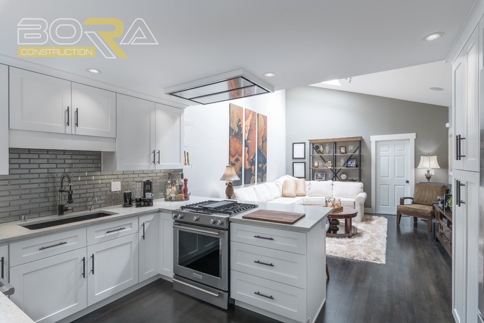 Eat-in kitchen - mid-sized transitional u-shaped dark wood floor and brown floor eat-in kitchen idea with an undermount sink, recessed-panel cabinets, white cabinets, wood countertops, metallic backsplash, ceramic backsplash, stainless steel appliances and a peninsula