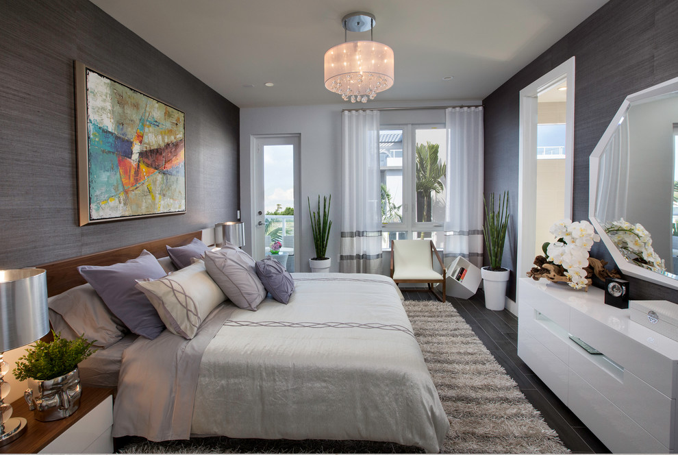 Photo of a mid-sized contemporary master bedroom in Miami with grey walls and dark hardwood floors.