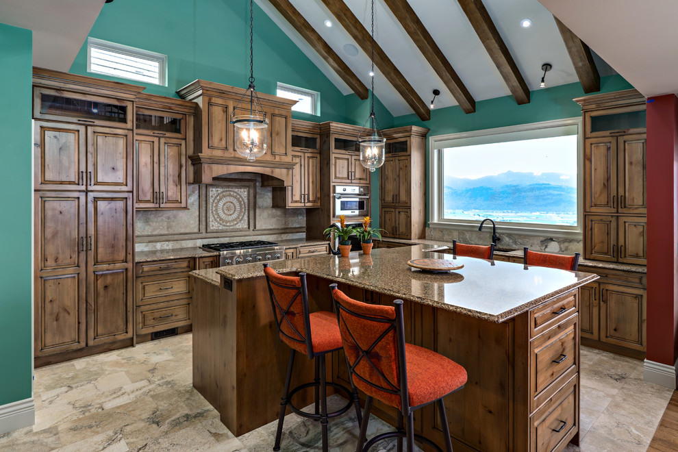 Inspiration for a mid-sized transitional u-shaped travertine floor eat-in kitchen remodel in Vancouver with a double-bowl sink, raised-panel cabinets, medium tone wood cabinets, granite countertops, brown backsplash, stone tile backsplash, stainless steel appliances and an island