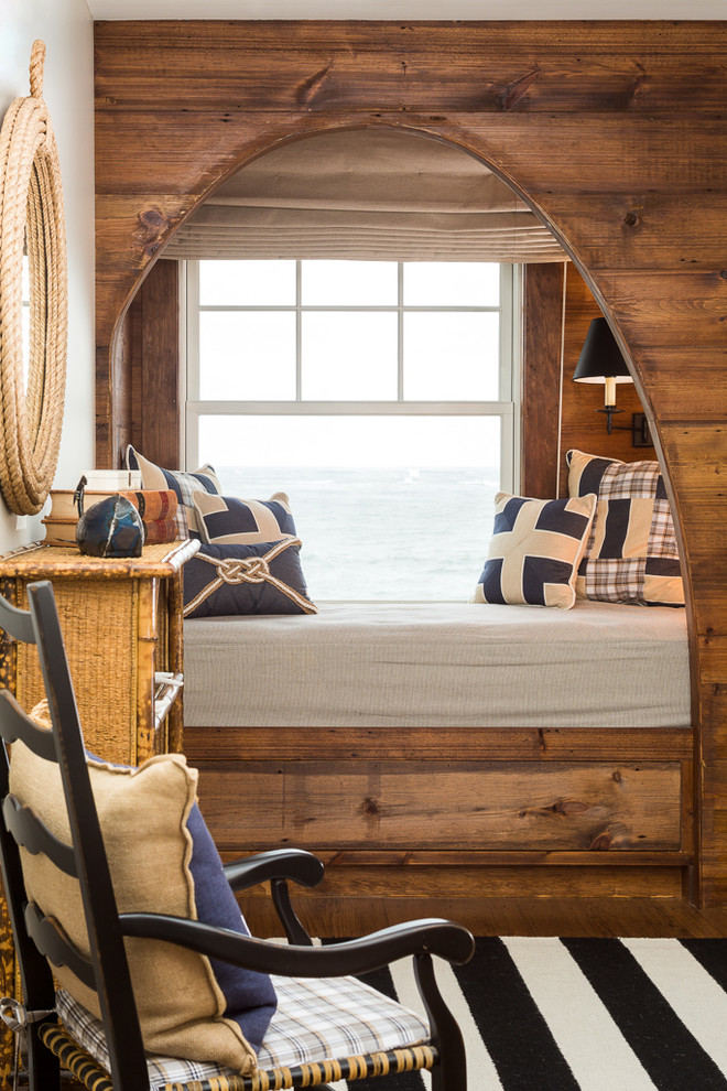 Photo of a beach style bedroom in Portland Maine with medium hardwood floors.