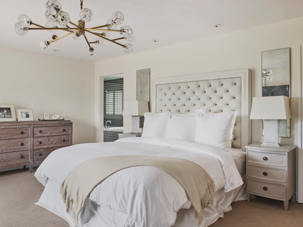 Large mediterranean master bedroom in Phoenix with beige walls, carpet and grey floor.