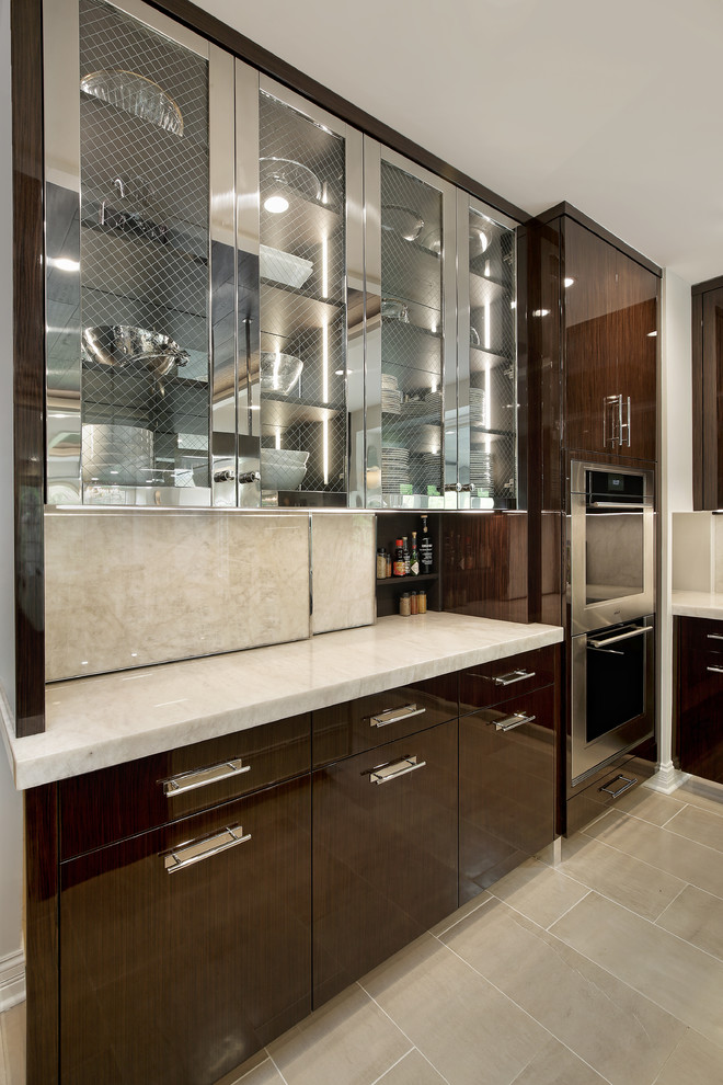 Photo of an expansive modern u-shaped open plan kitchen in Chicago with a triple-bowl sink, flat-panel cabinets, stainless steel cabinets, quartzite benchtops, white splashback, stone slab splashback, stainless steel appliances, porcelain floors, with island, beige floor and white benchtop.