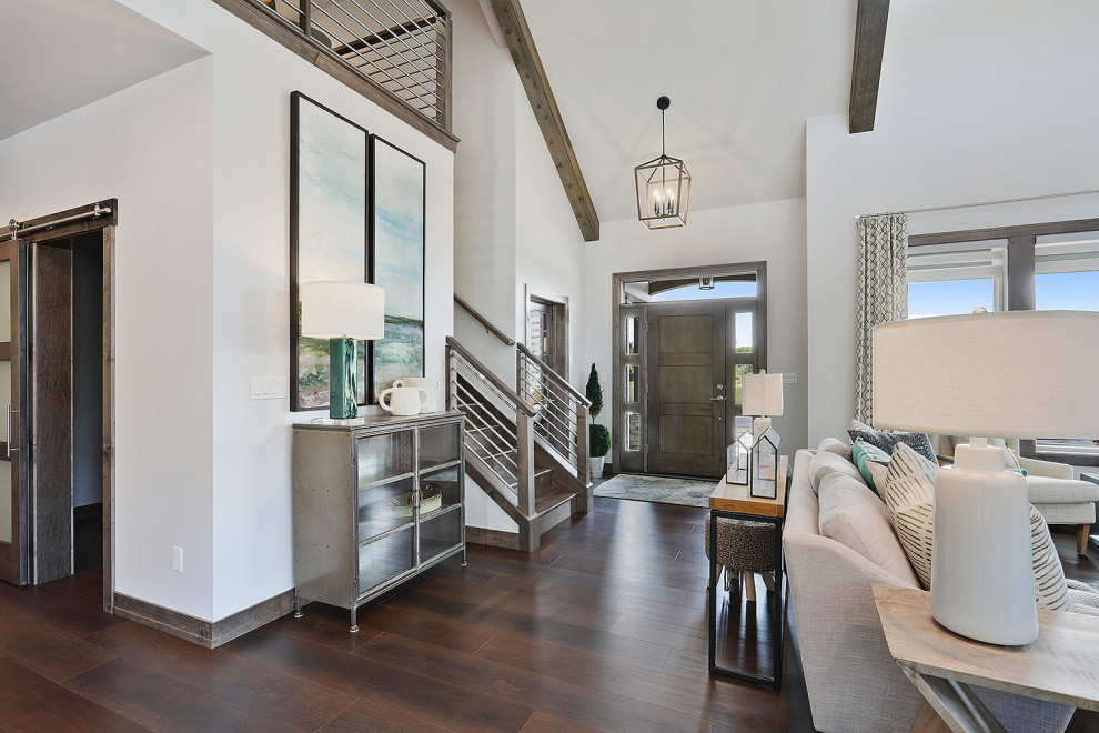 Mid-sized transitional brown floor and dark wood floor front door photo with white walls and a dark wood front door