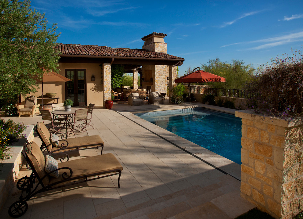 Inspiration for a mid-sized traditional backyard rectangular lap pool in Phoenix with tile.