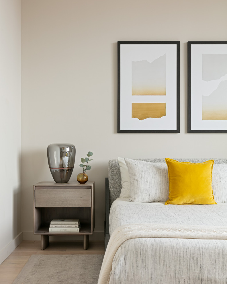 Mid-sized minimalist master light wood floor and brown floor bedroom photo in New York with beige walls