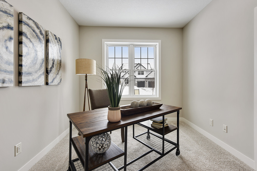 This is an example of a large transitional study room in Minneapolis with grey walls, carpet, a freestanding desk and white floor.