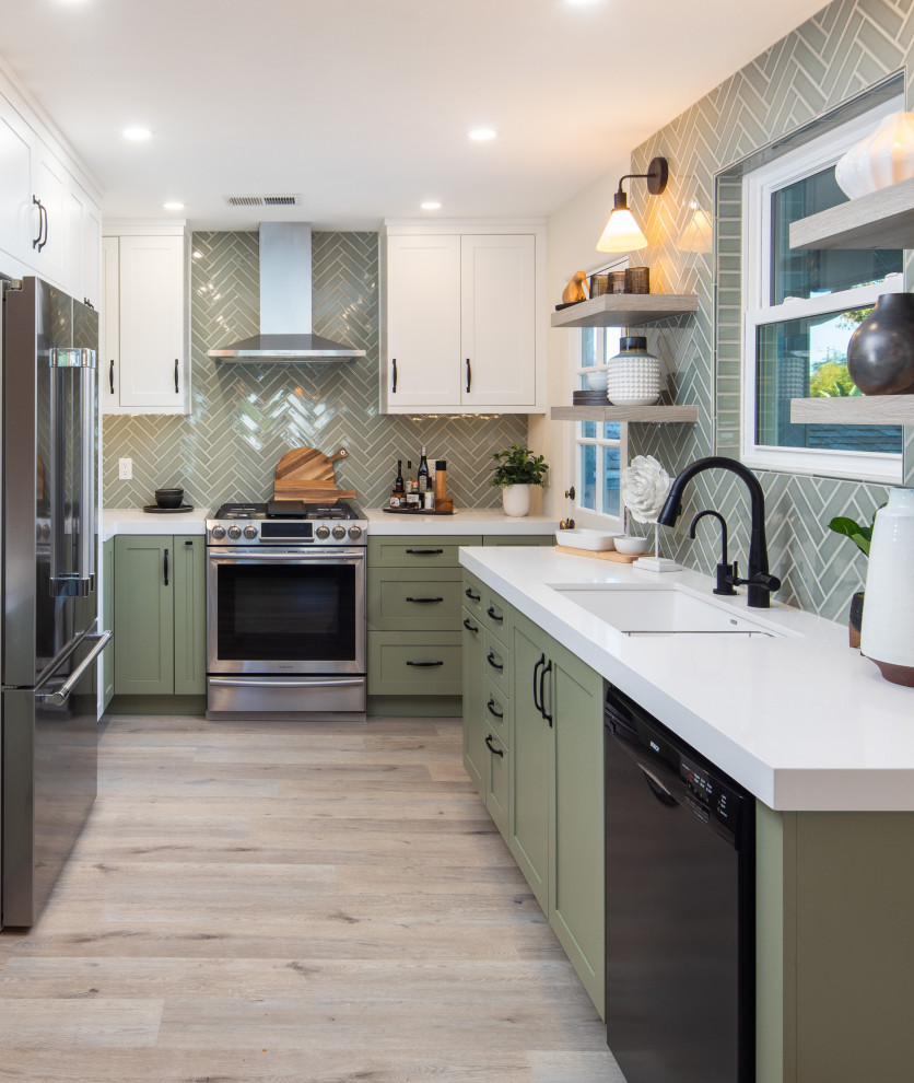 Photo of a medium sized traditional u-shaped kitchen/diner in San Diego with a submerged sink, shaker cabinets, green cabinets, engineered stone countertops, green splashback, ceramic splashback, stainless steel appliances, vinyl flooring, no island, grey floors and white worktops.