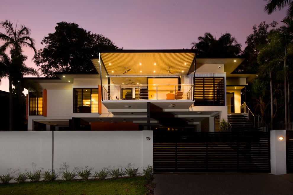 Design ideas for a large tropical two-storey white exterior in Darwin with mixed siding and a flat roof.