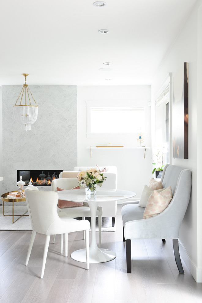 Mid-sized transitional medium tone wood floor dining room photo in Vancouver with white walls, a stone fireplace and a ribbon fireplace